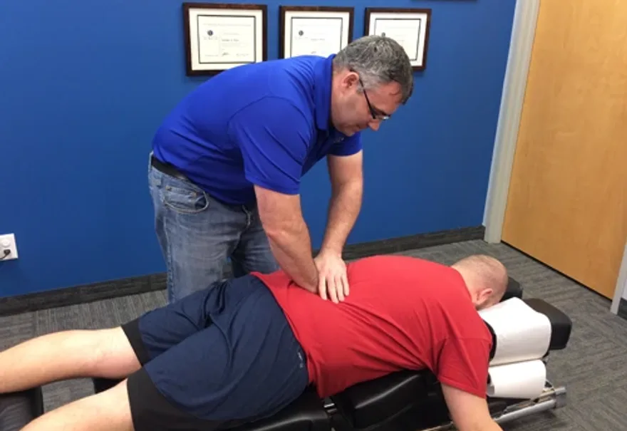 Dr. Nathan Weiss, D.C. performing a chiropractic adjustment at True North Chiropractic Center